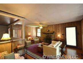 231 Woodland Road Tryon, NC 28782 - Photo 12 of 24 a living room with furniture a window and kitchen view
