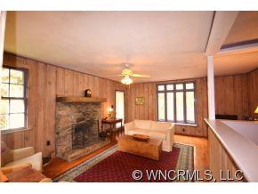 231 Woodland Road Tryon, NC 28782 - Photo 13 of 24 a living room with a fireplace furniture and a large window