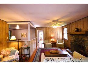 231 Woodland Road Tryon, NC 28782 - Photo 14 of 24 a living room with furniture a flat screen tv and a fireplace