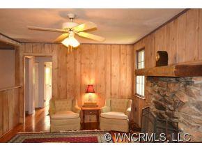 231 Woodland Road Tryon, NC 28782 - Photo 15 of 24 a view of a livingroom with furniture and chandelier fan