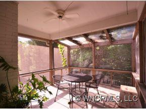 231 Woodland Road Tryon, NC 28782 - Photo 16 of 24 a view of a porch with a table and chairs