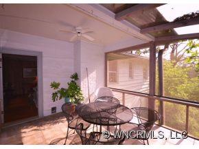 231 Woodland Road Tryon, NC 28782 - Photo 17 of 24 a view of a porch with furniture and a yard