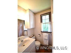 231 Woodland Road Tryon, NC 28782 - Photo 18 of 24 a bathroom with a sink and a mirror