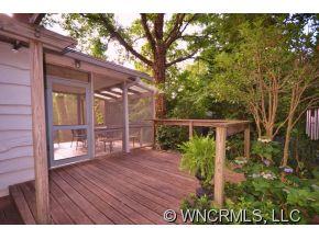 231 Woodland Road Tryon, NC 28782 - Photo 6 of 24 a view of backyard with plants and wooden fence