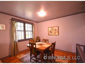 231 Woodland Road Tryon, NC 28782 - Photo 10 of 24 a view of a dining room with furniture window and wooden floor