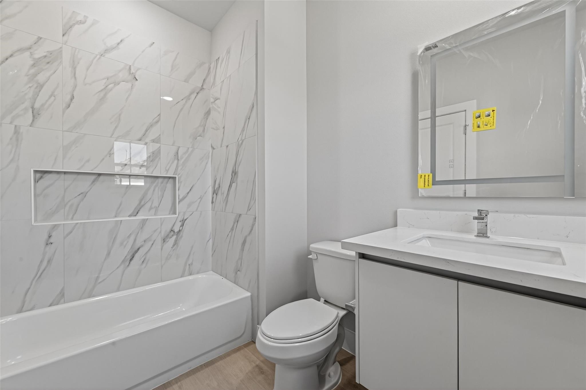 6702 Metro Boulevard, Unit 8 Houston, TX 77083 - Photo 20 of 36 a bathroom with a sink toilet and bathtub