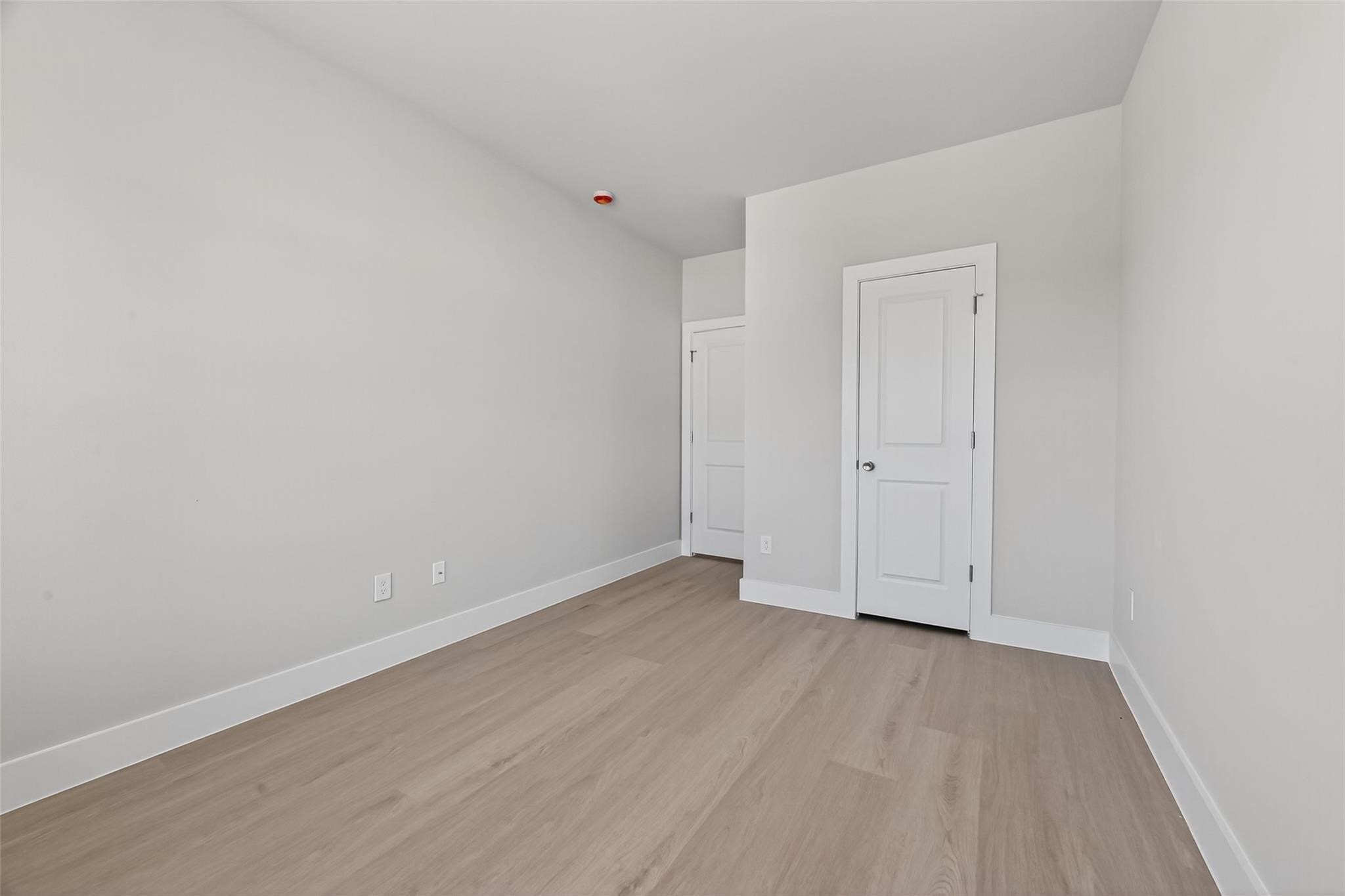 6702 Metro Boulevard, Unit 8 Houston, TX 77083 - Photo 21 of 36 an empty room with wooden floor