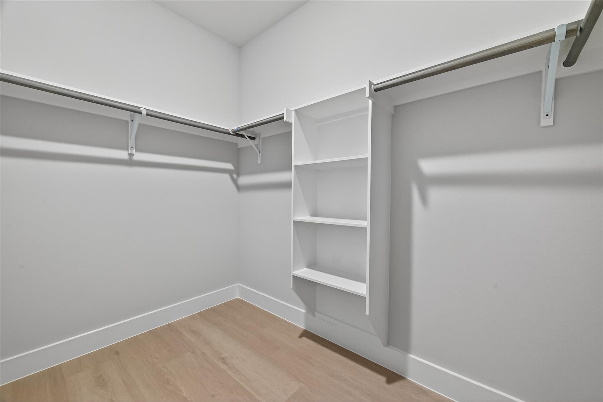 6702 Metro Boulevard, Unit 8 Houston, TX 77083 - Photo 26 of 36 a view of walk in closet with empty racks