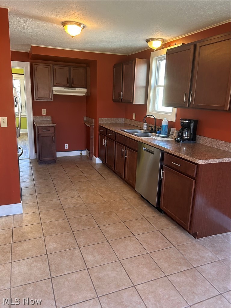 1001 Englewood Road Cleveland Heights, OH 44121 - Photo 28 of 28 Kitchen featuring a textured ceiling, dishwasher, light tile patterned flooring, extractor fan, and light countertops