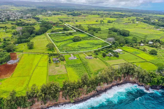 an aerial view of a golf course with a lake view