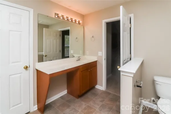 a bathroom with a sink a toilet and mirror