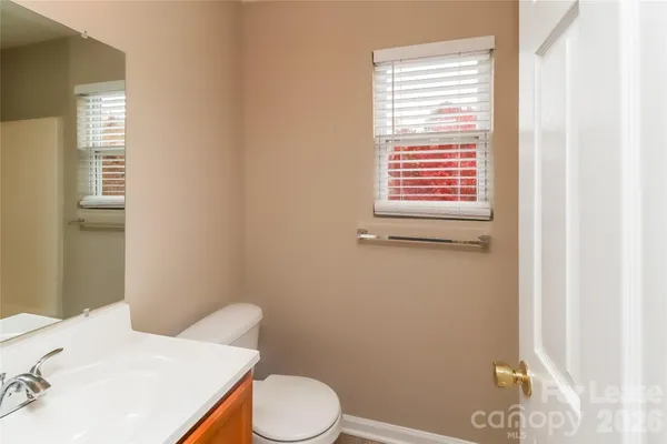 a white toilet sitting next to a bathroom sink