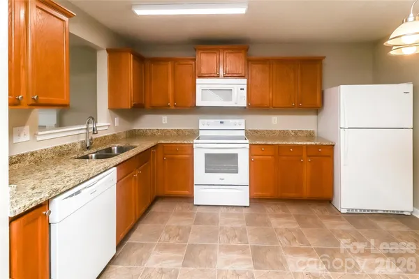 a kitchen with a stove a sink a microwave and refrigerator