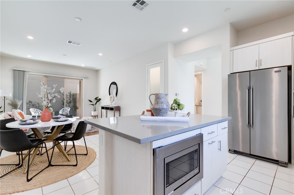 800 Beacon Irvine, CA 92618 - Photo 13 of 49 a kitchen with stainless steel appliances granite countertop a refrigerator and a stove top oven