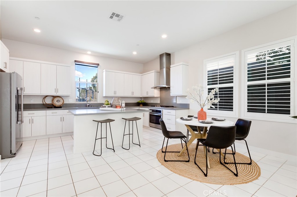 800 Beacon Irvine, CA 92618 - Photo 10 of 49 a kitchen with a sink chairs and cabinets