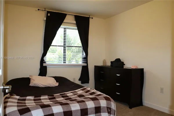 a bedroom with a bed and a shower
