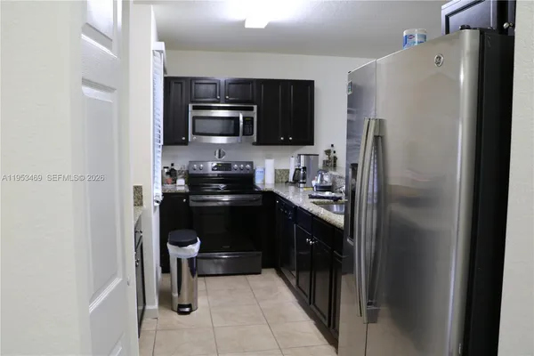 a kitchen with a refrigerator a stove and a sink