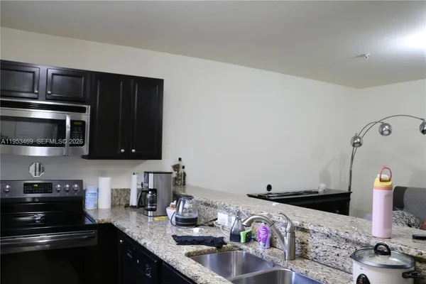 a kitchen with stainless steel appliances wooden cabinets and a sink