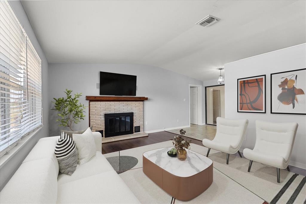 4070 McNeil Road Apopka, FL 32703 - Photo 3 of 28 a living room with furniture a fireplace and a flat screen tv