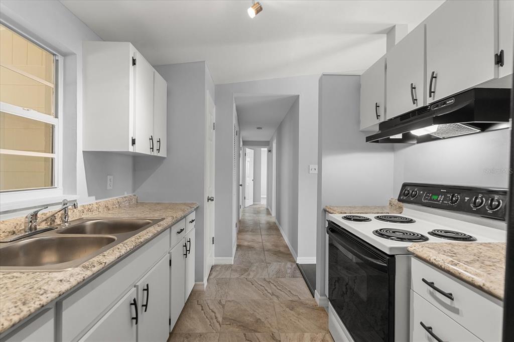 4070 McNeil Road Apopka, FL 32703 - Photo 8 of 28 a kitchen that has a sink and a stove