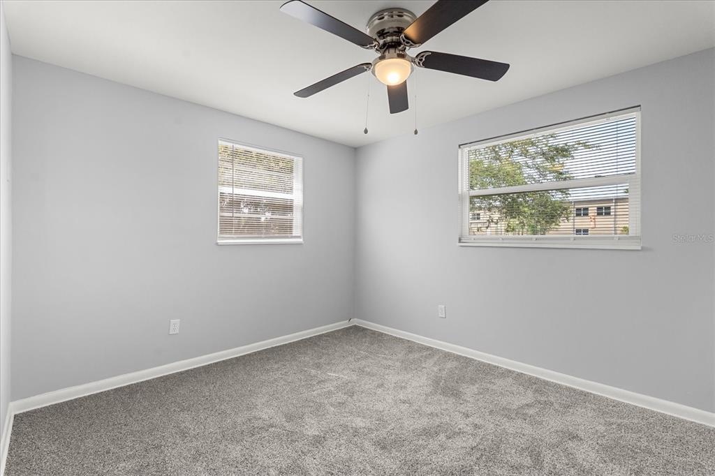 4070 McNeil Road Apopka, FL 32703 - Photo 9 of 28 an empty room with a window and a fan