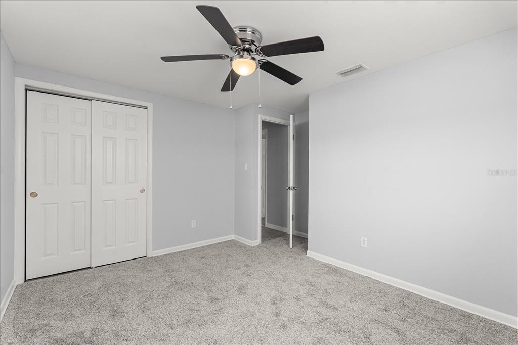 4070 McNeil Road Apopka, FL 32703 - Photo 10 of 28 an empty room with ceiling fan