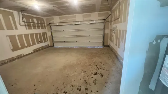 a view of a house with a yard and a large tree