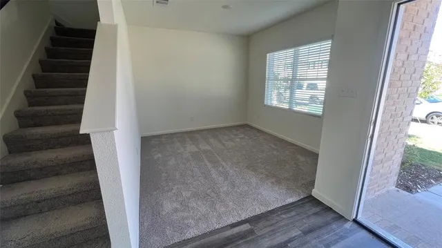 an entryway with wooden floor and windows