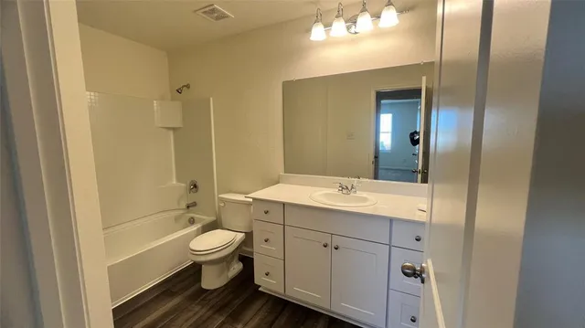 a view of an empty room and a window