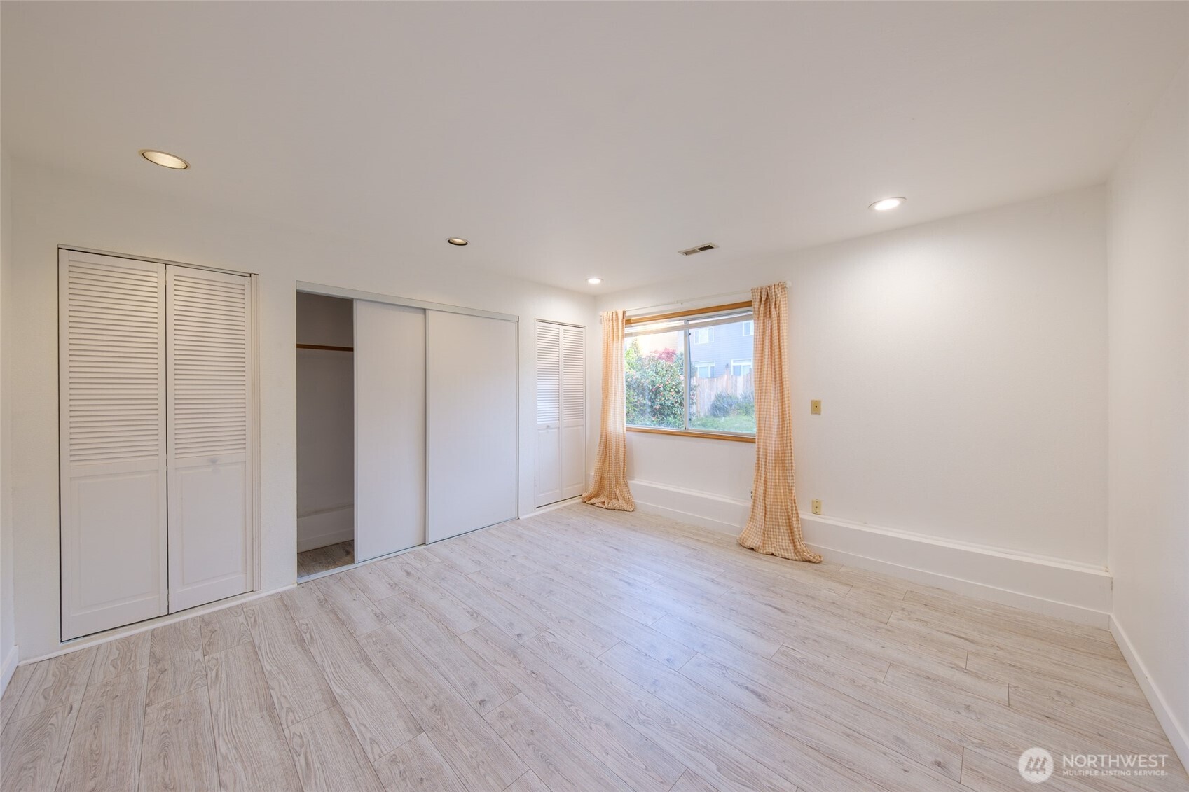 830 234th Street Southeast Bothell, WA 98021 - Photo 16 of 26 a view of an empty room with wooden floor and a window