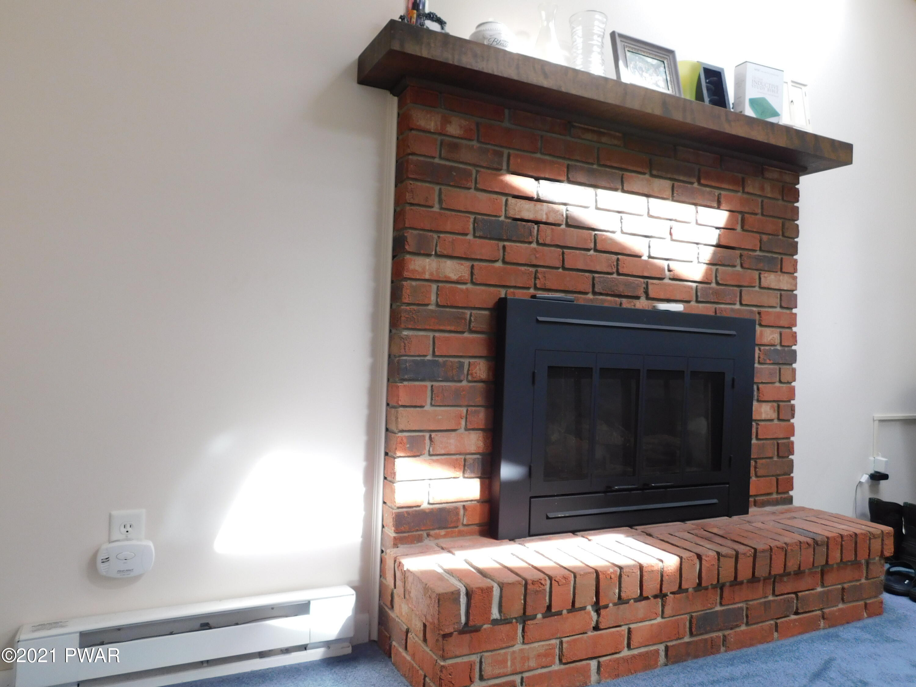 119 Ridge Drive Milford, PA 18337 - Photo 12 of 40 a bedroom with a bed and a fireplace