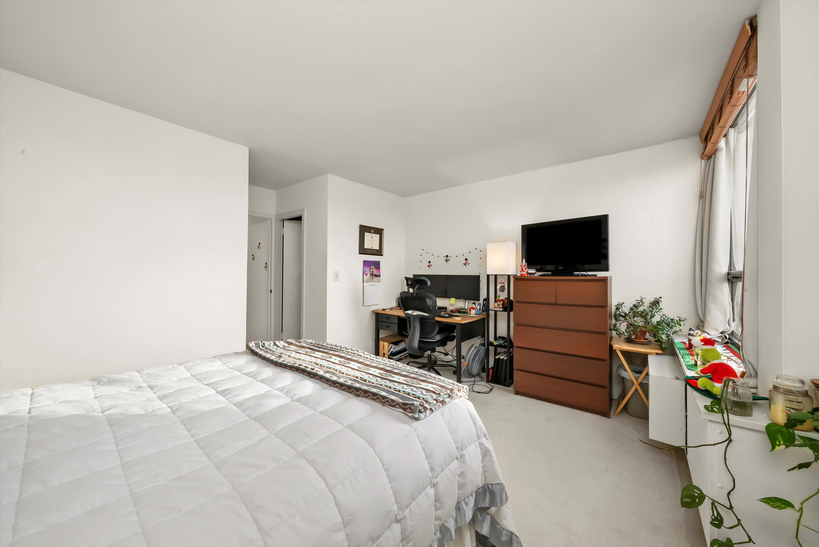 1455 North Sandburg Terrace, Unit 801 Chicago, IL 60610 - Photo 14 of 23 a bedroom with a bed and a flat screen tv