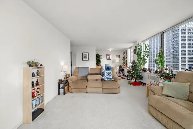a living room with furniture and a large window