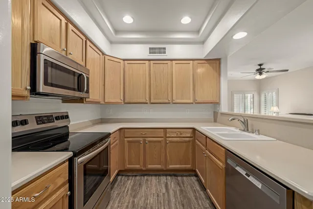 a kitchen with a sink stove and microwave
