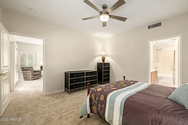 a bedroom with a bed and ceiling fan