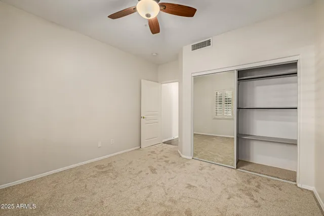 an empty room with a empty space and a ceiling fan
