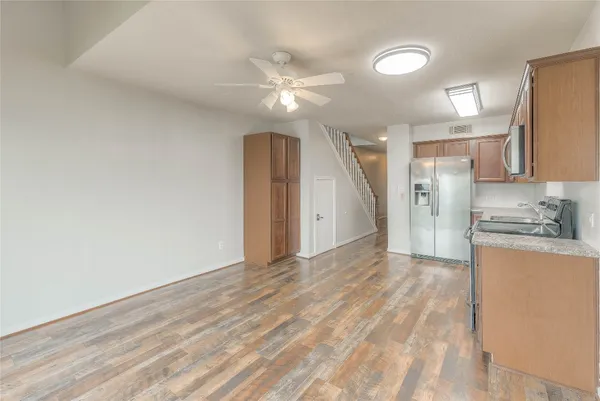 a view of a kitchen with a sink and a refrigerator