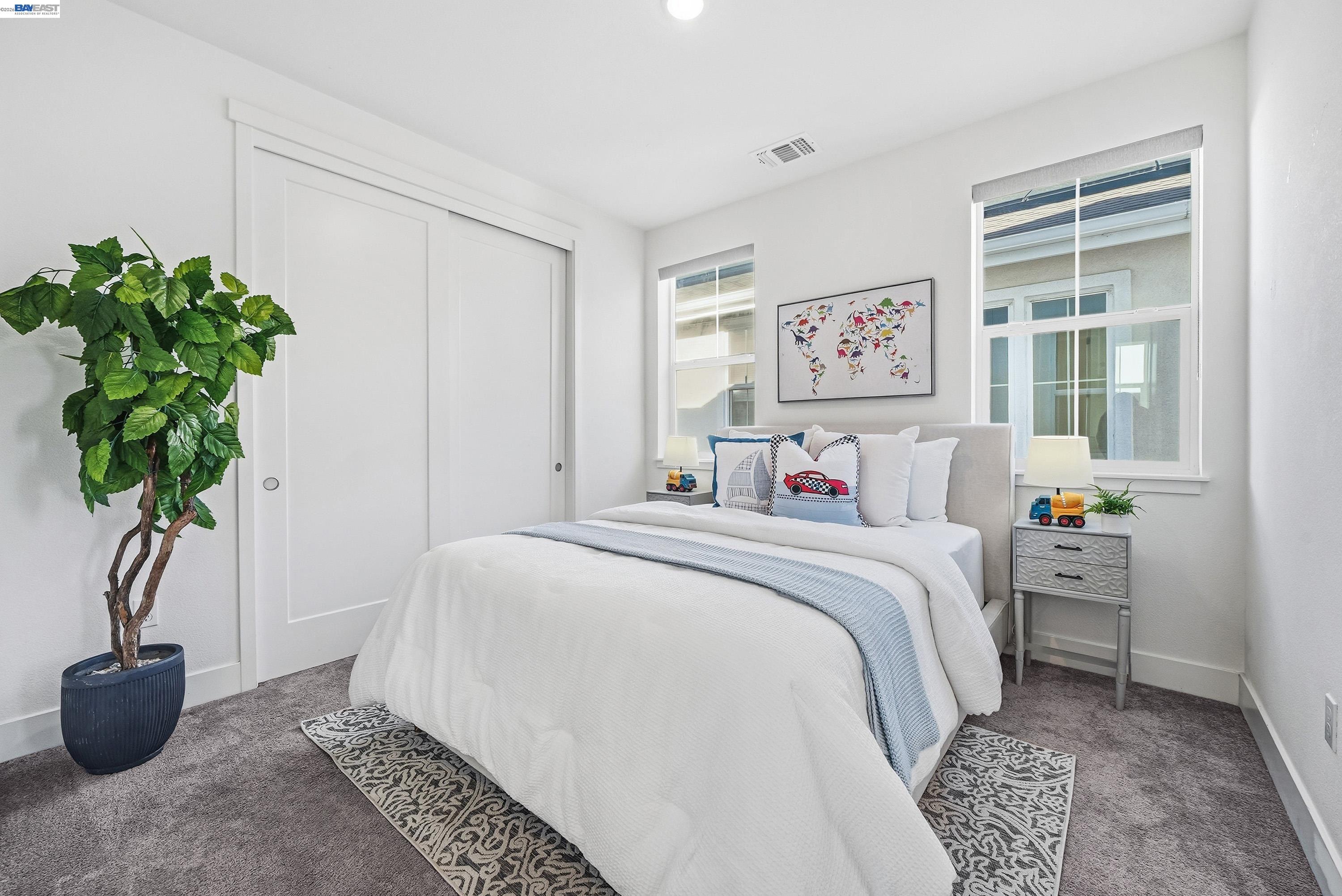 37645 Bay Crest Road Newark, CA 94560 - Photo 22 of 46 a spacious bedroom with a bed and a potted plant