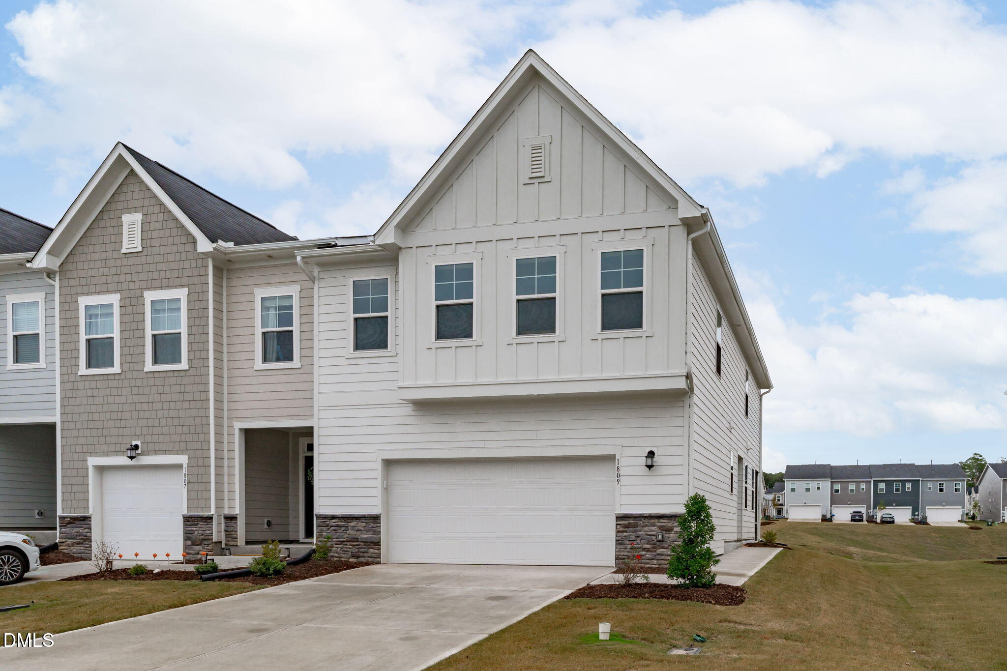 1809 Barrett Run Trail Apex, NC 27502 - Photo 2 of 37 a front view of a house with a yard and garage