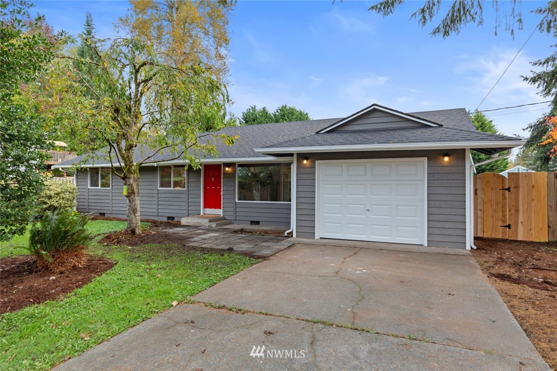 20711 Filbert Drive Bothell, WA 98012 - Photo 1 of 25 a front view of a house with a yard and garage