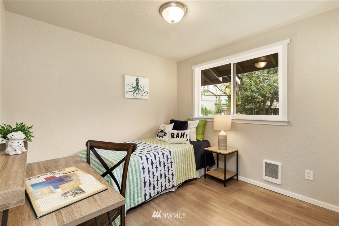 20711 Filbert Drive Bothell, WA 98012 - Photo 17 of 25 a bedroom with a bed and wooden floor