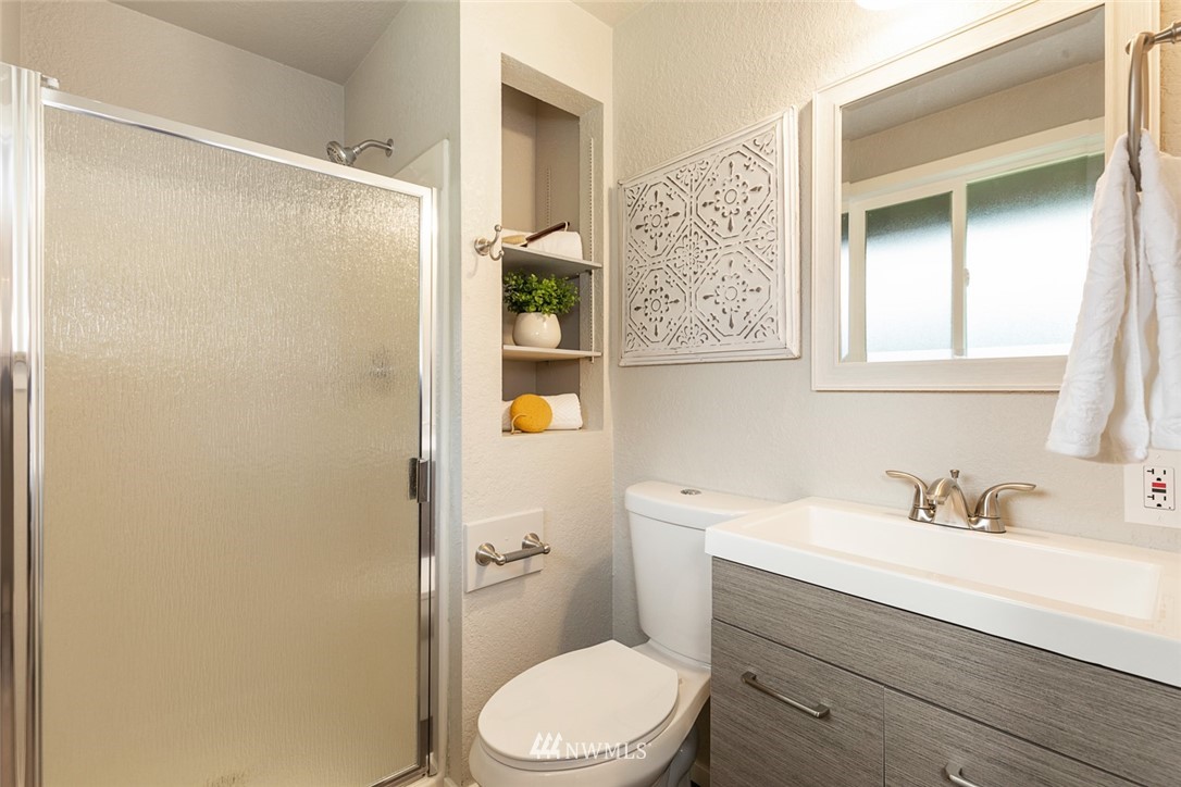 20711 Filbert Drive Bothell, WA 98012 - Photo 21 of 25 a bathroom with a sink a mirror and a toilet