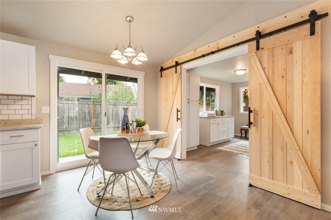 20711 Filbert Drive Bothell, WA 98012 - Photo 7 of 25 a view of a dining room with furniture window and wooden floor