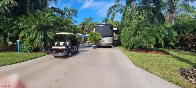 a view of a two chairs in a patio with a small yard