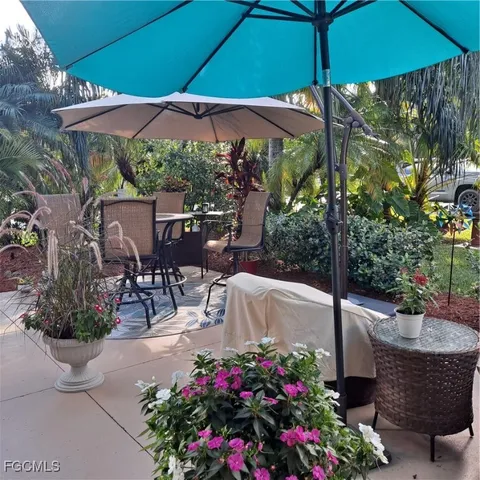 a view of a chairs and table under an umbrella