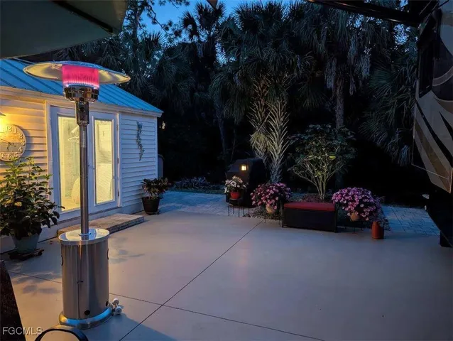 a view of a house with a yard and a cars park fire pit