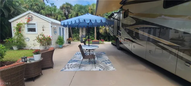 a view of a patio with table and chairs and potted plants