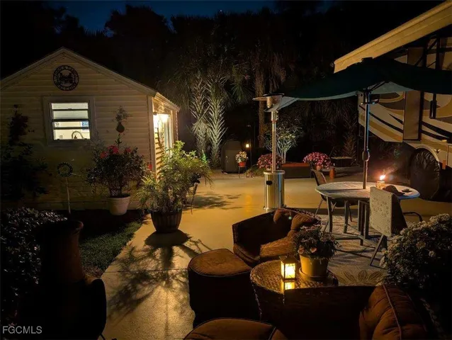 a view of a house with backyard porch and sitting area