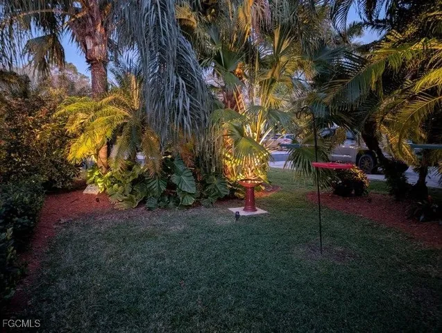 a view of yard with swimming pool and trees