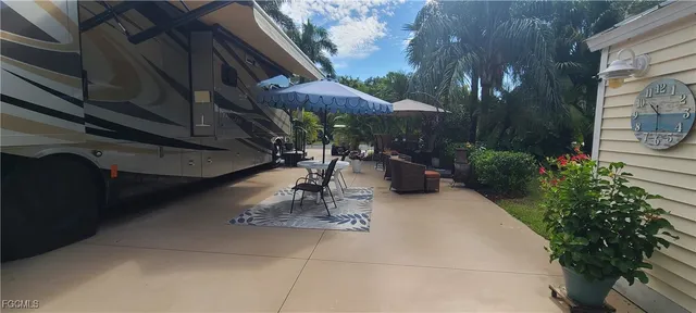 a view of a patio with table and chairs potted plants